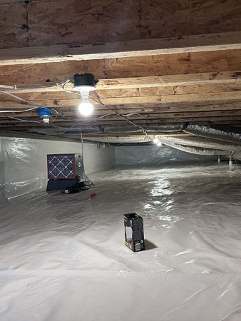 A room with a white tarp spread across the floor, creating a clean and protected surface.