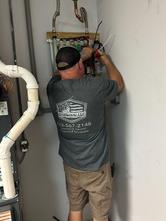 A man is focused on repairing a furnace in a well-lit room filled with tools and equipment.