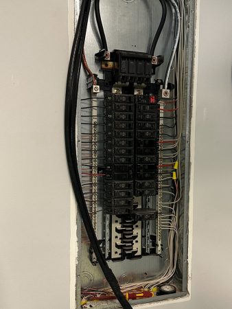 A panel containing various wires and electrical equipment, showcasing a complex arrangement of connections and components.